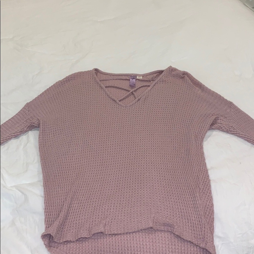 Pink sweater with cross detail on the chest
